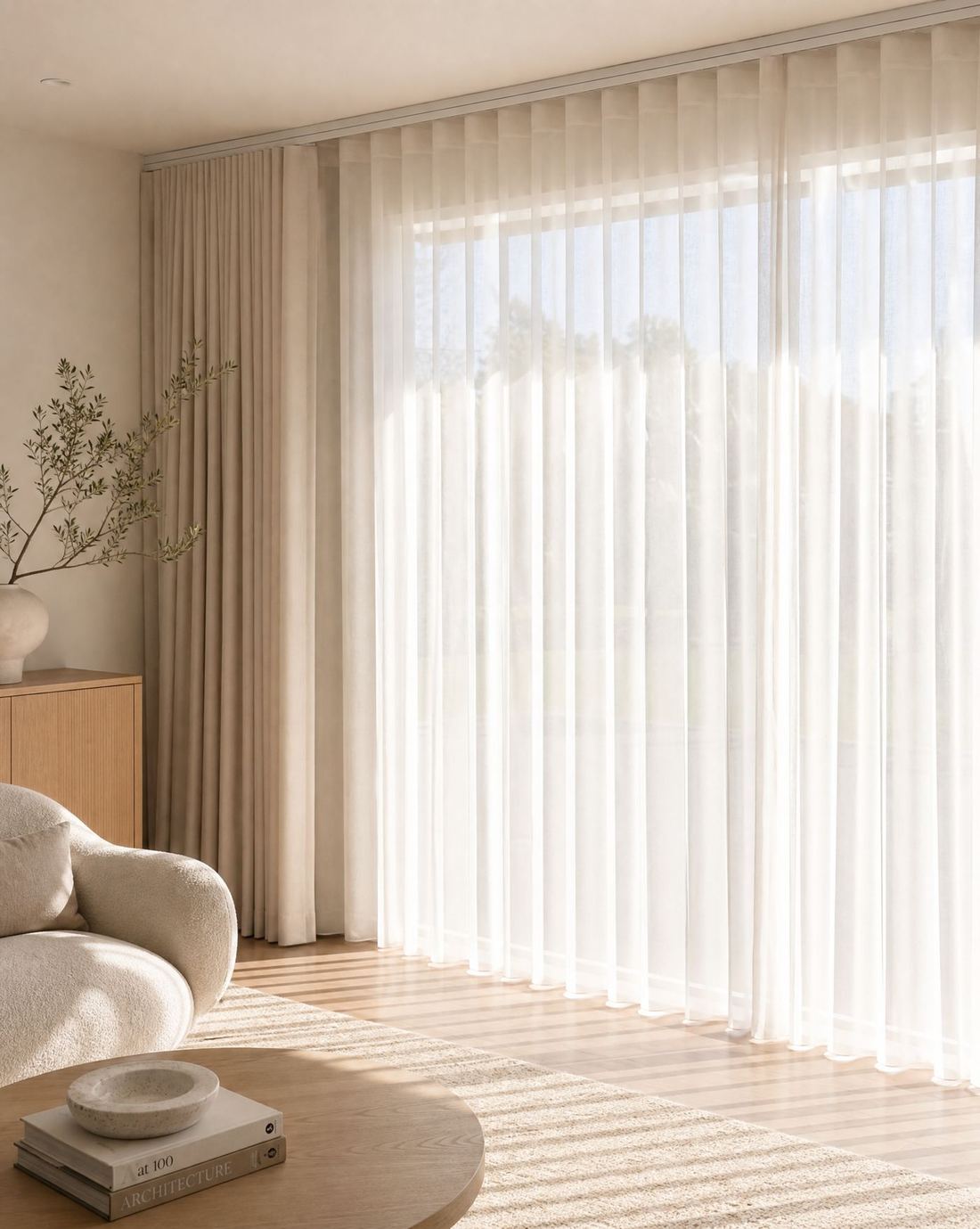 Floor to ceiling sheer curtains with blockout side panels in a sunlit living room
